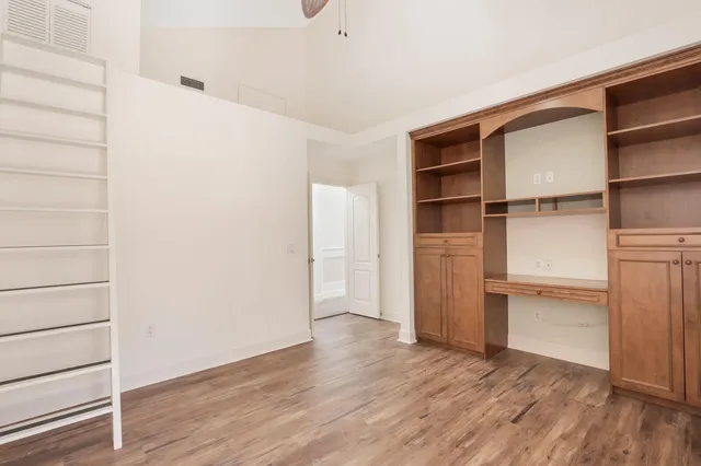 a view of walk in closet with empty racks