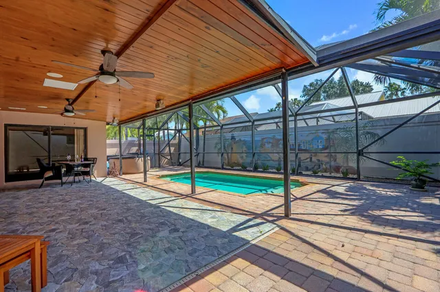 a view of a backyard with a patio and a yard