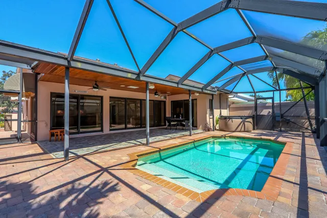 a view of a backyard with table and chairs under an umbrella
