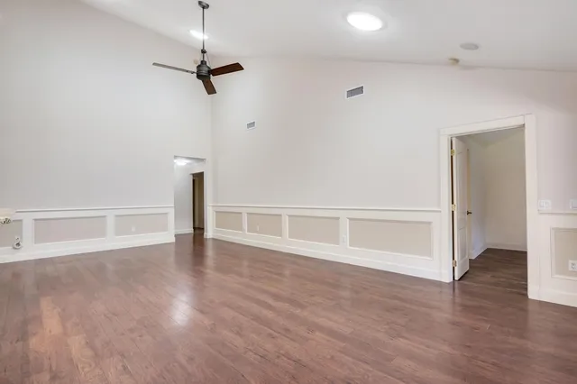 a view of an empty room with wooden floor