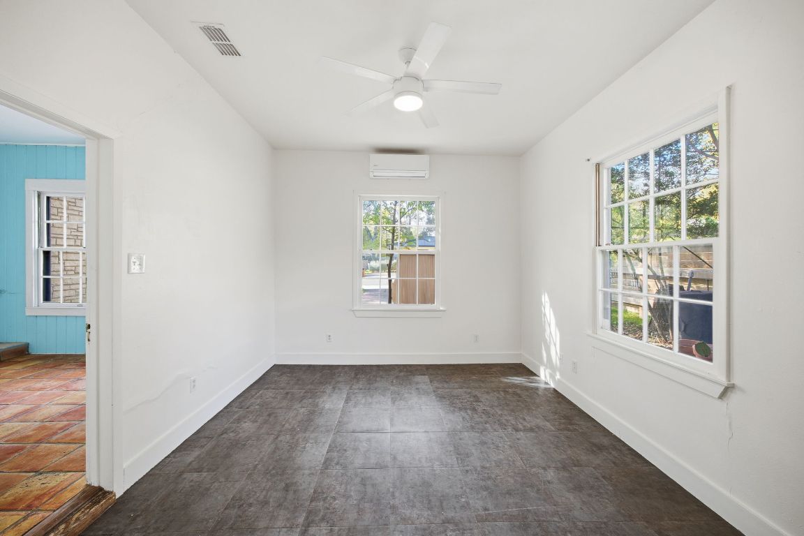 1706 East 38th 1/2 Street Austin, TX 78722 - Photo 10 of 24 an empty room with wooden floor and windows