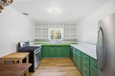 a kitchen with stainless steel appliances granite countertop a sink and cabinets