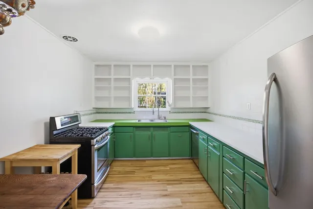 a kitchen with stainless steel appliances granite countertop a sink and cabinets