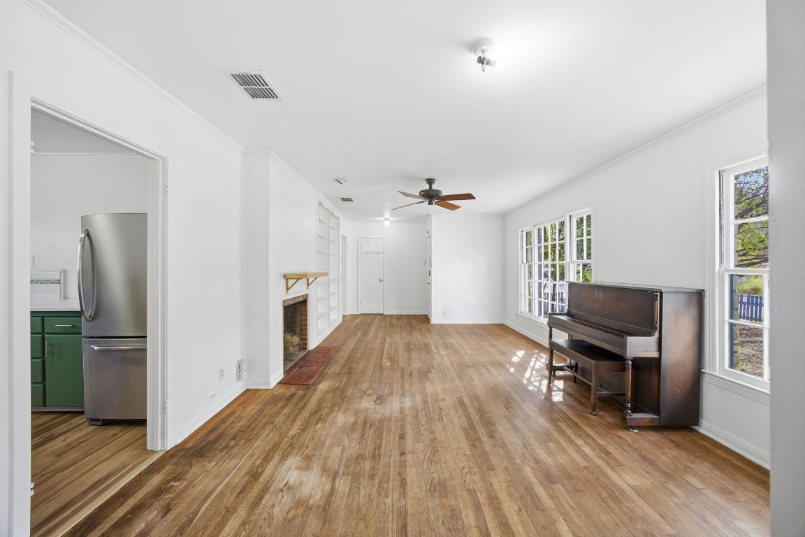 1706 East 38th 1/2 Street Austin, TX 78722 - Photo 13 of 24 a view of a livingroom with furniture a ceiling fan and wooden floor