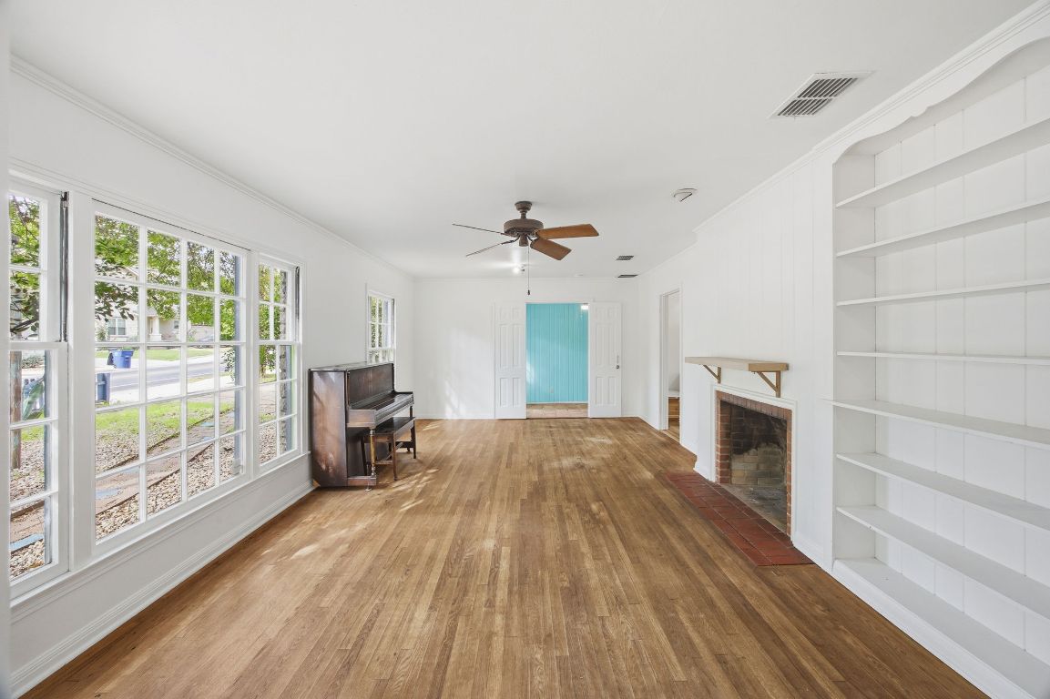 1706 East 38th 1/2 Street Austin, TX 78722 - Photo 14 of 24 a view of empty room with wooden floor and fireplace