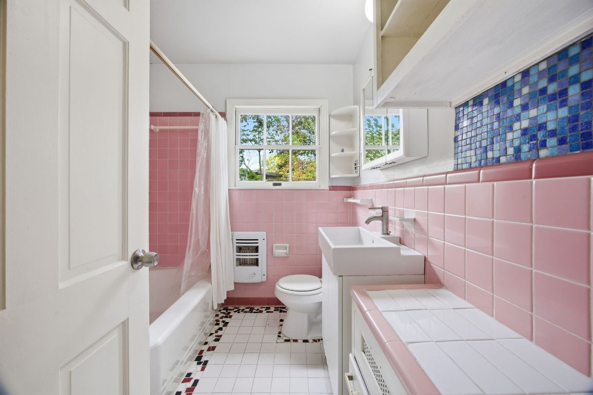 1706 East 38th 1/2 Street Austin, TX 78722 - Photo 16 of 24 a bathroom with a sink a toilet and shower curtain