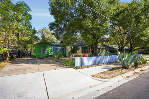 a view of a street with a large tree
