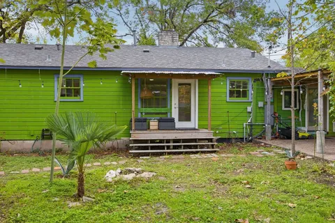 a front view of a house with a garden and plants