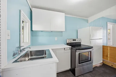 a kitchen with a stove and a refrigerator