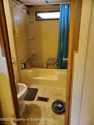 a bathroom with a tub and shower