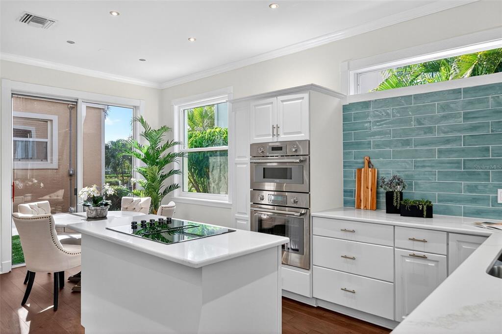 3488 Mistletoe Lane Longboat Key, FL 34228 - Photo 16 of 82 a kitchen with stainless steel appliances a sink a potted plant and a counter space