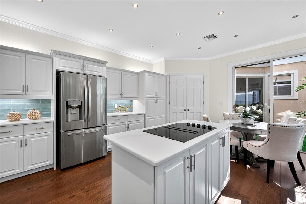 3488 Mistletoe Lane Longboat Key, FL 34228 - Photo 17 of 82 a kitchen that has a sink a refrigerator and chairs