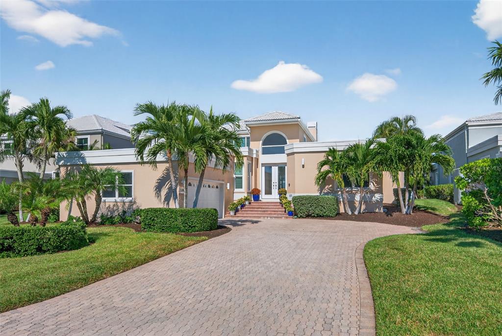 3488 Mistletoe Lane Longboat Key, FL 34228 - Photo 2 of 82 a front view of a house with a yard and potted plants