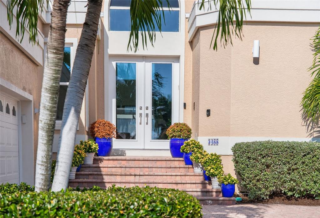 3488 Mistletoe Lane Longboat Key, FL 34228 - Photo 3 of 82 a front view of a house with a garden