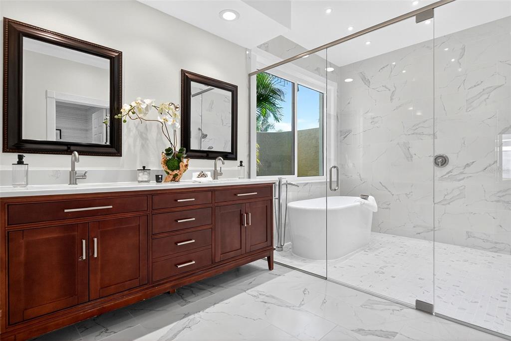 3488 Mistletoe Lane Longboat Key, FL 34228 - Photo 35 of 82 a bathroom with a double vanity sink toilet and shower