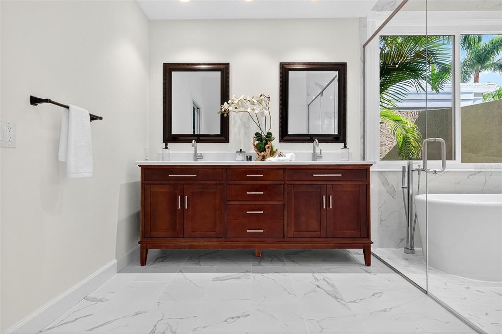 3488 Mistletoe Lane Longboat Key, FL 34228 - Photo 36 of 82 a bathroom with a granite countertop sink and a mirror