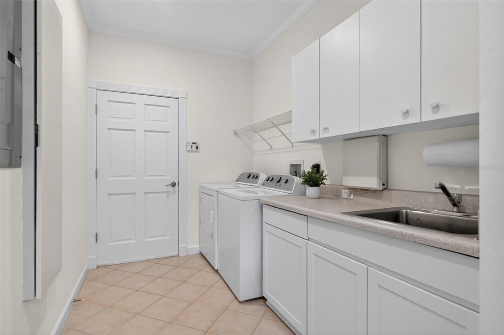 3488 Mistletoe Lane Longboat Key, FL 34228 - Photo 49 of 82 a kitchen with white cabinets and sink