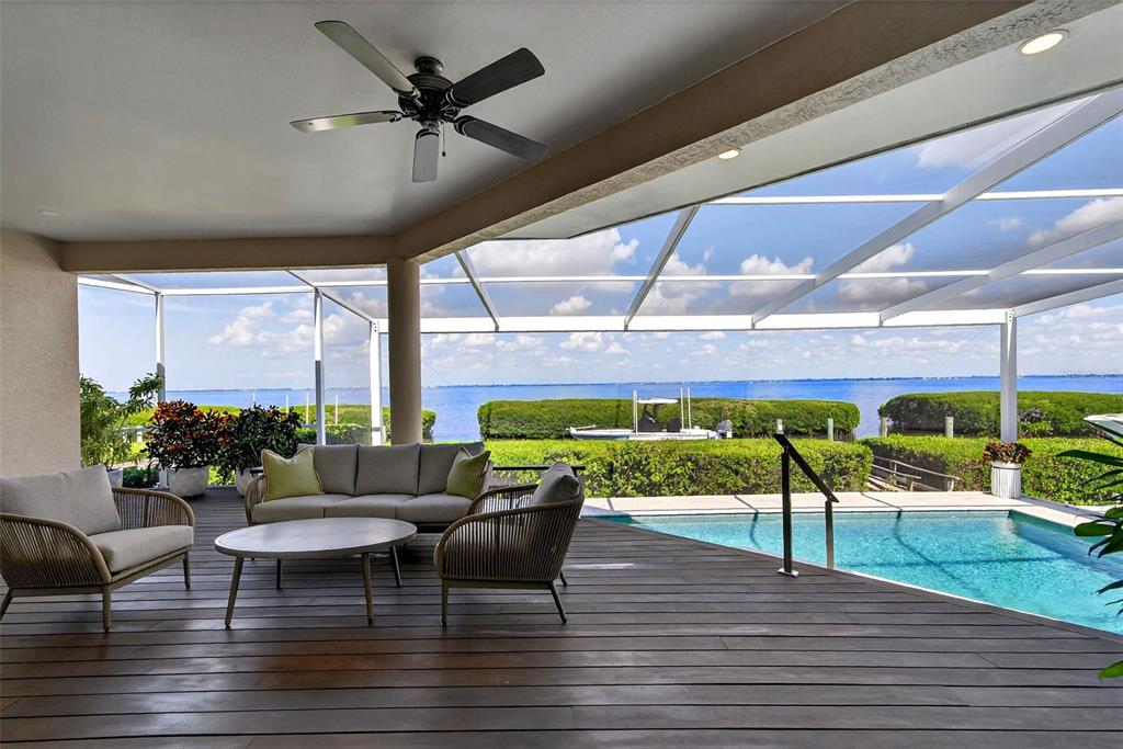 3488 Mistletoe Lane Longboat Key, FL 34228 - Photo 51 of 82 a view of a patio with a table and chairs