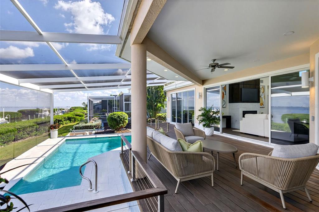 3488 Mistletoe Lane Longboat Key, FL 34228 - Photo 52 of 82 a living room with patio furniture and a flat screen tv