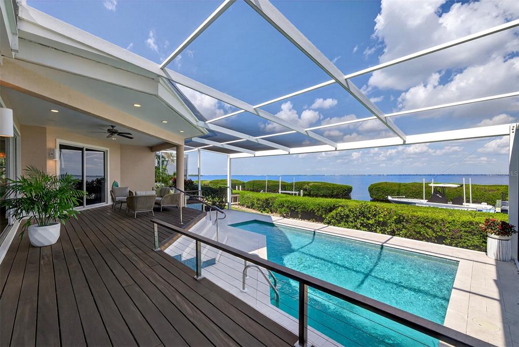 3488 Mistletoe Lane Longboat Key, FL 34228 - Photo 56 of 82 a view of a chairs and table in a patio
