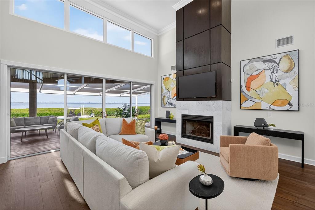 3488 Mistletoe Lane Longboat Key, FL 34228 - Photo 6 of 82 a living room with furniture fireplace and flat screen tv