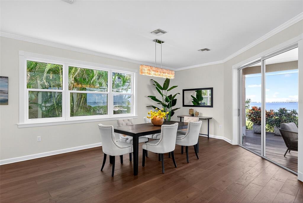3488 Mistletoe Lane Longboat Key, FL 34228 - Photo 9 of 82 a view of a dining room with furniture window and wooden floor