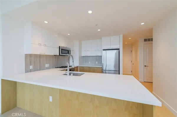 a view of a hallway with wooden shelves