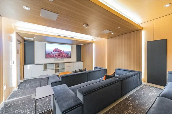 a living room with furniture pool table and flat screen tv