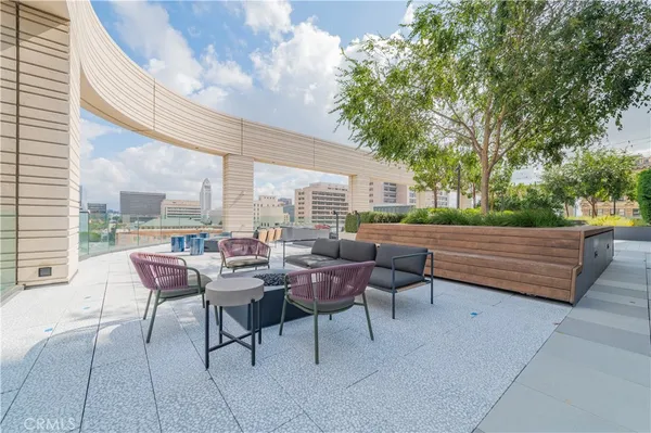 a view of a dining room with furniture a chandelier and wooden floor