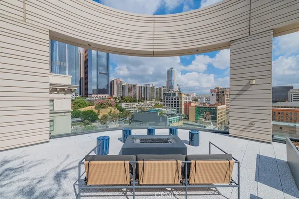 a view of a kitchen with a sink and dishwasher a stove top oven with wooden floor