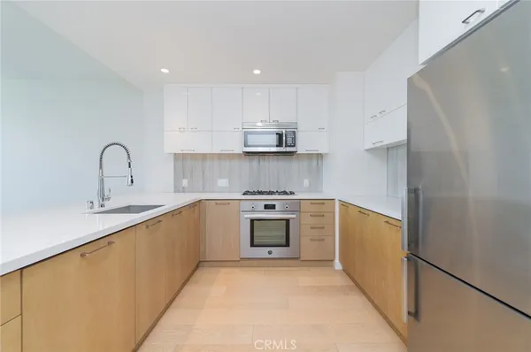 a kitchen with stainless steel appliances granite countertop a stove and a sink