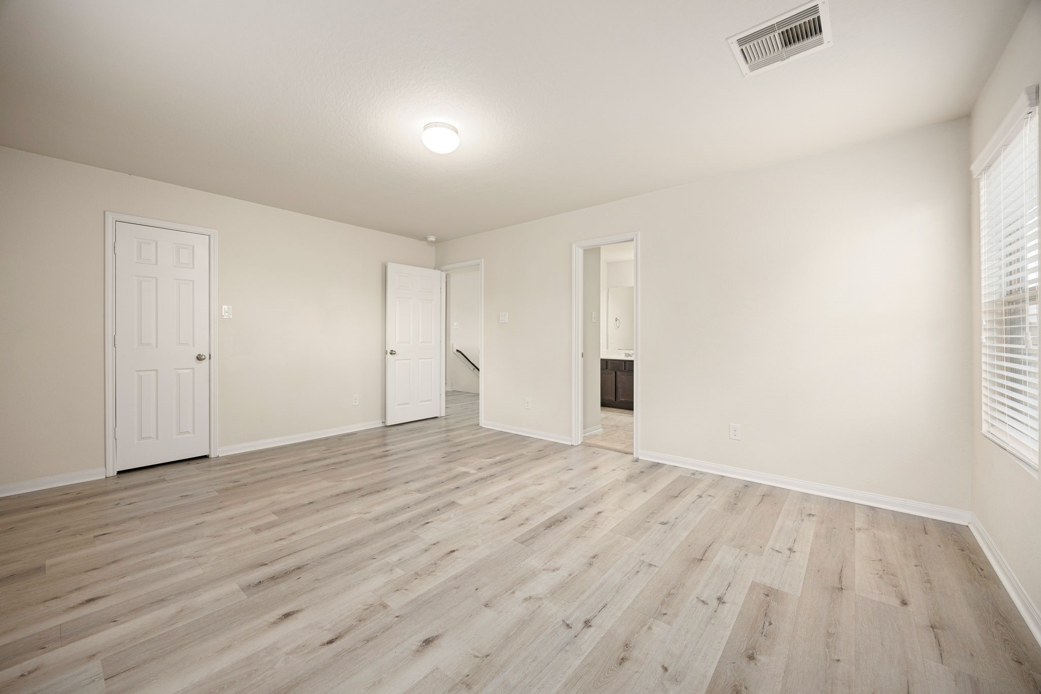 29322 Indian Clearing Spring, TX 77386 - Photo 31 of 47 a view of an empty room with wooden floor and a window