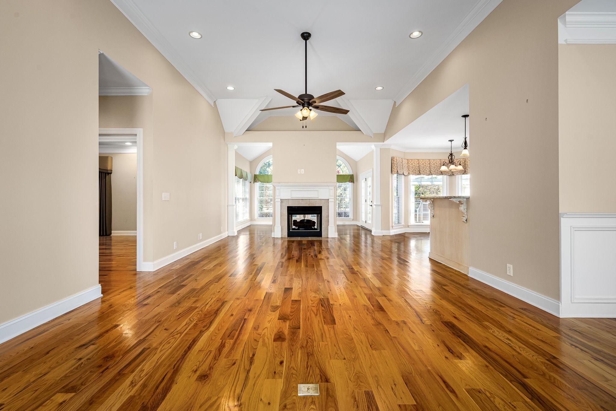 2101 Stratford Road Murfreesboro, TN 37129 - Photo 13 of 54 an empty room with wooden floor fireplace and windows