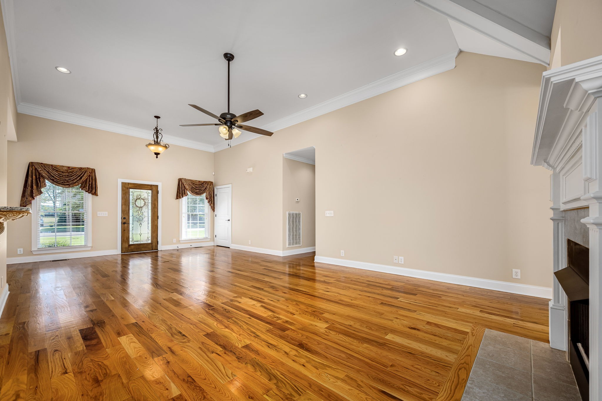 2101 Stratford Road Murfreesboro, TN 37129 - Photo 15 of 54 a view of a livingroom with wooden floor and a ceiling fan