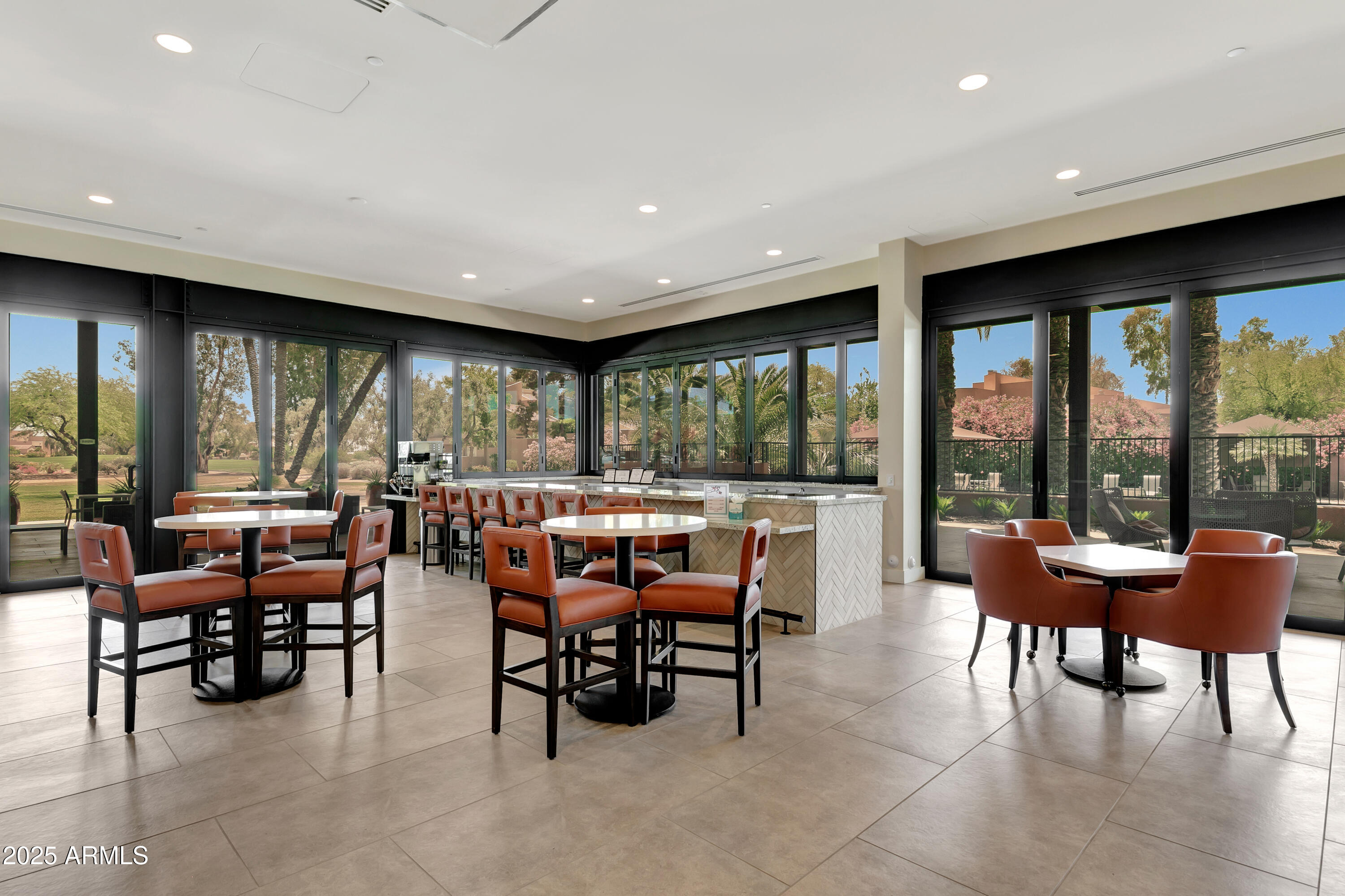 7710 East Gainey Ranch Road, Unit 229 Scottsdale, AZ 85258 - Photo 30 of 50 a view of a big room with furniture and floor to ceiling window