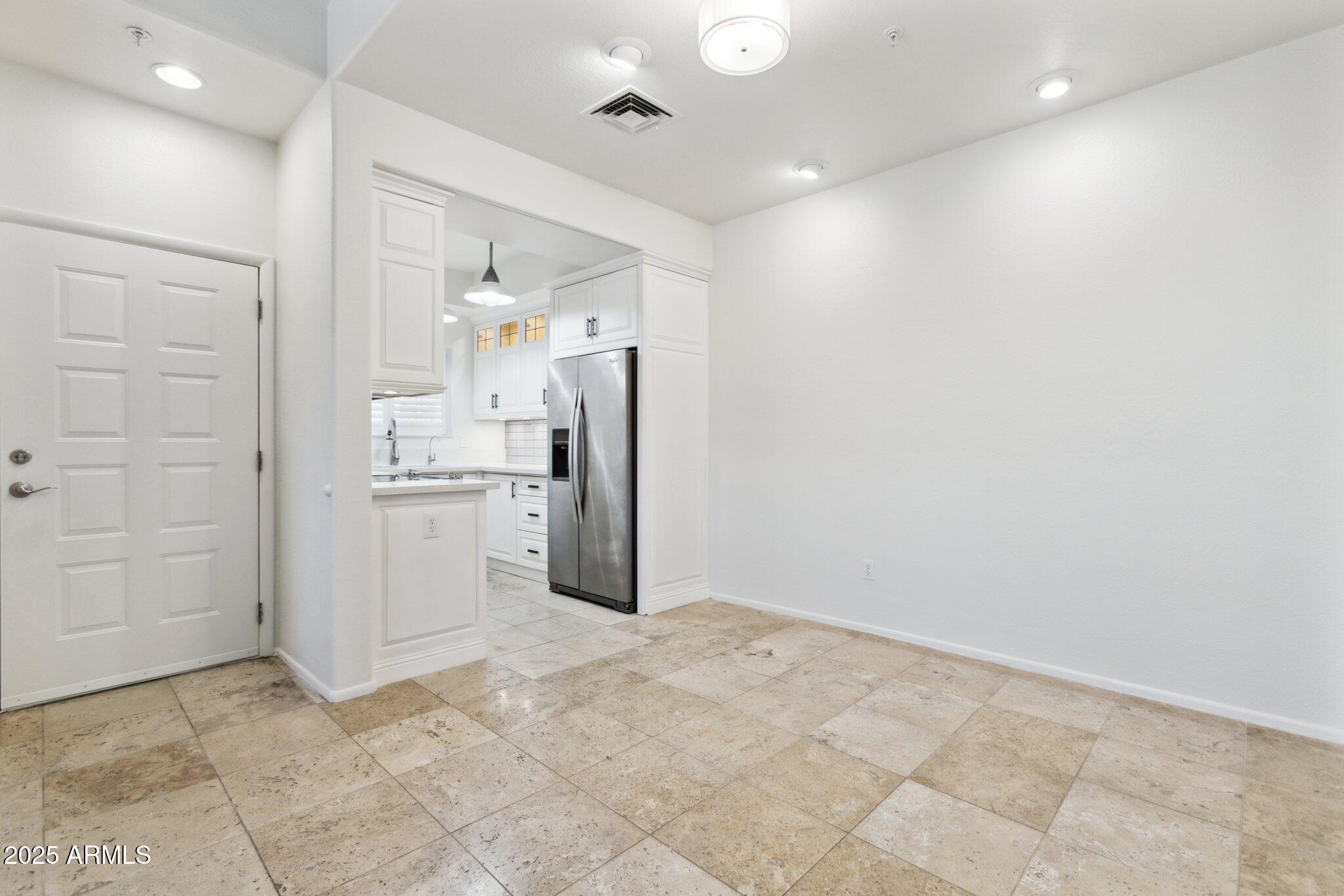 7710 East Gainey Ranch Road, Unit 229 Scottsdale, AZ 85258 - Photo 3 of 50 a view of kitchen with refrigerator and cabinets
