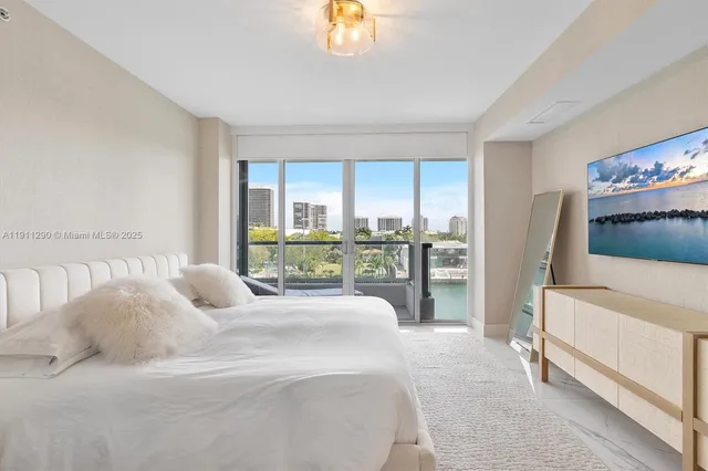 a bedroom with a bed and a large window with the outer view
