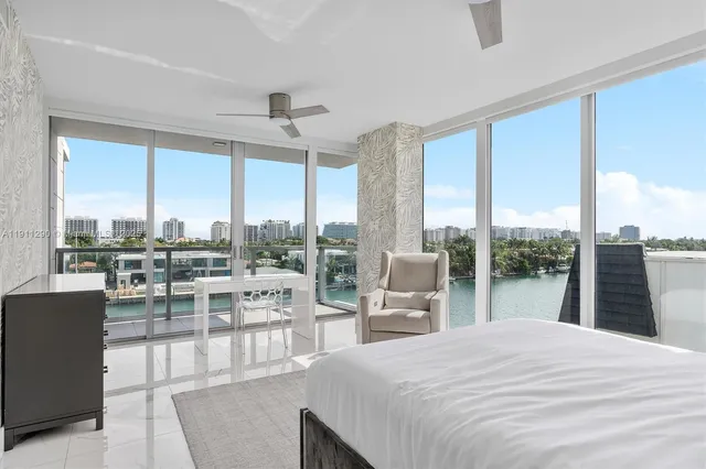 a bedroom with a bed and a large window