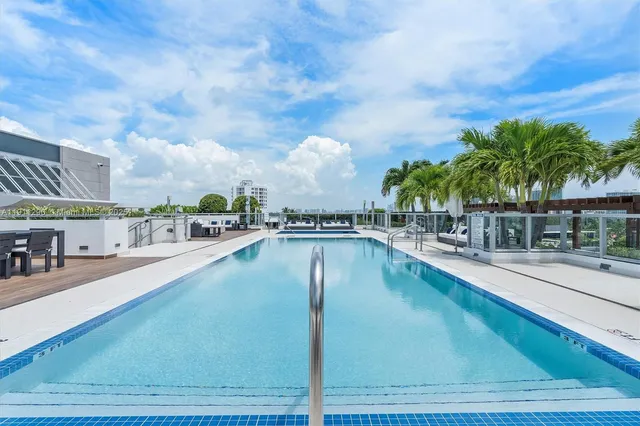 a view of swimming pool with outdoor seating and plants