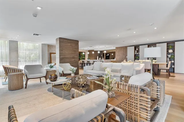 a living room with lots of furniture and a large window