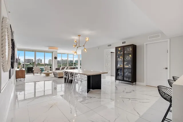 a living room with furniture a fireplace and a table with wooden floor
