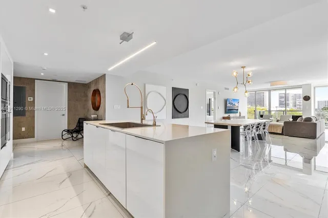 a large kitchen with lots of counter top space and living room