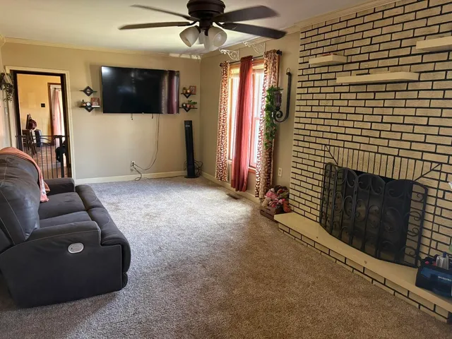 a living room with furniture and a flat screen tv