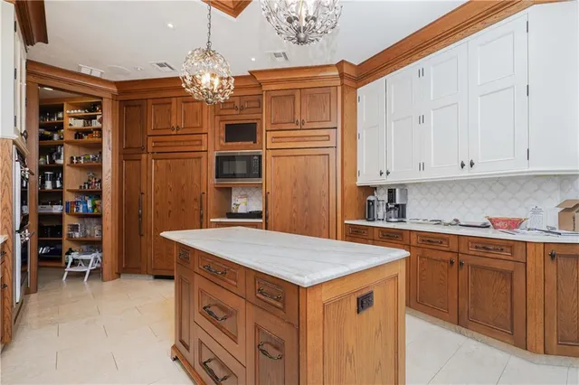 a kitchen that has a lot of cabinets in it