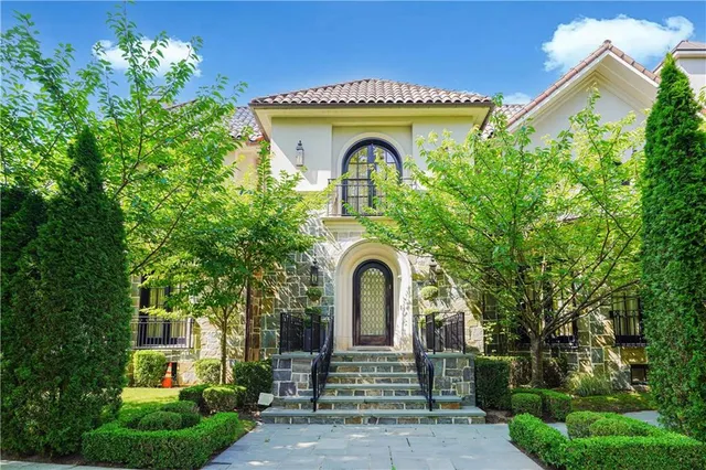 a front view of a house with garden