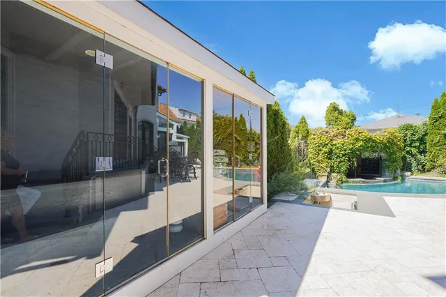 a view of a patio with couches table and chairs and potted plants