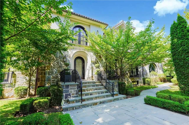 a front view of a house with a garden