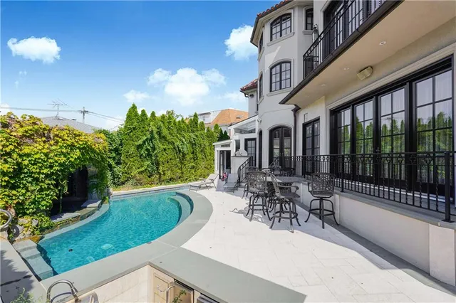 a swimming pool with outdoor seating and yard