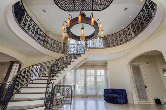 a view of staircase with lots of frames on wall and a large windows
