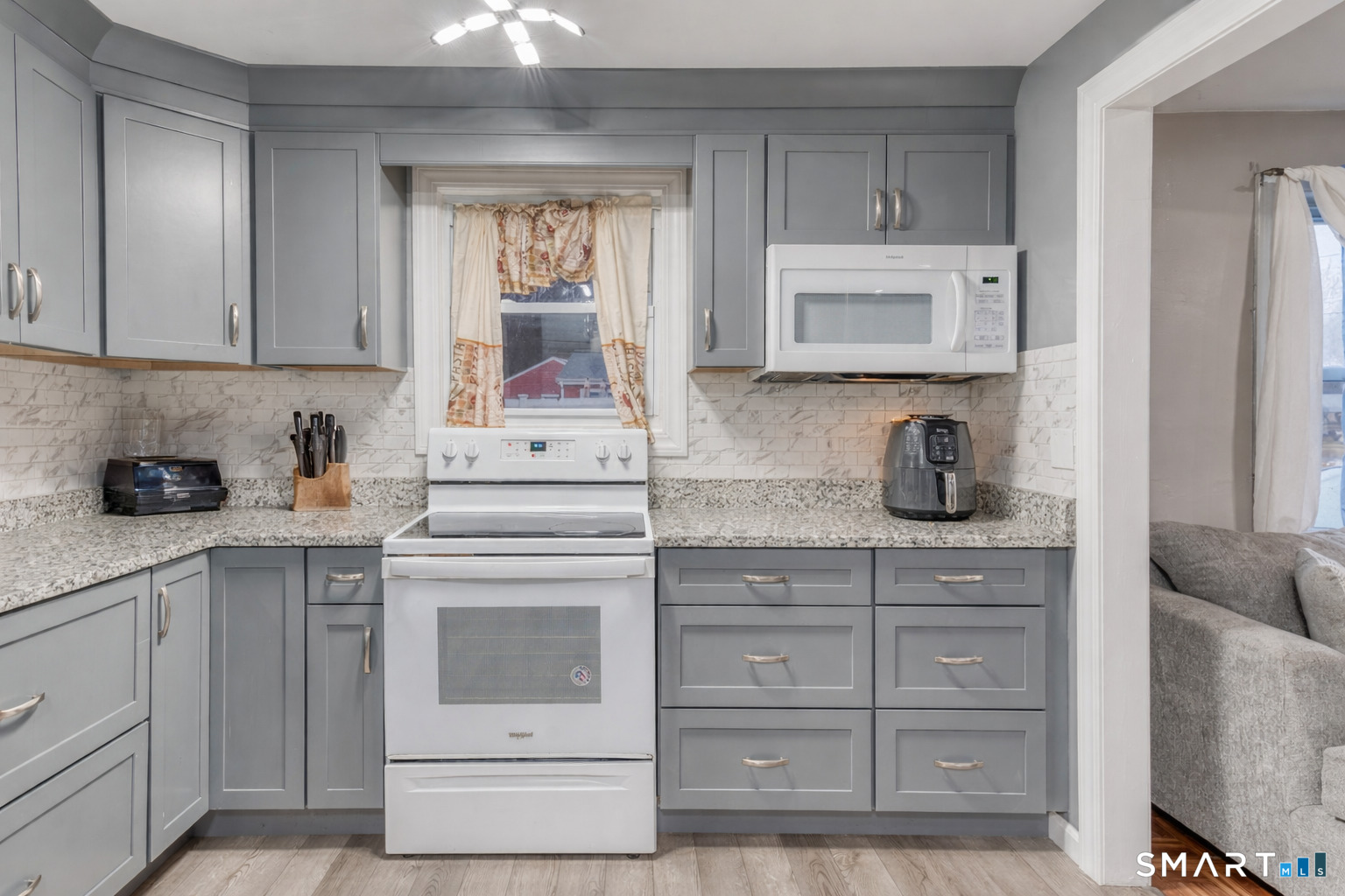 40 Cottage Grove Circle Bloomfield, CT 06002 - Photo 5 of 22 a kitchen with cabinets appliances a sink and a window